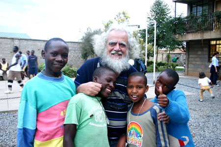 Kizita Sesana flanked by kids