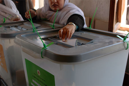 An Afghan casts her ballot during presidential elections in Kabul