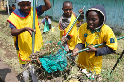 Children volunteers cleaning up their neighborhood in Mathare, Kenya