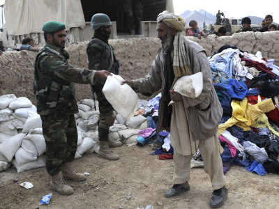 An Afghan man receives supplies during a humanitarian aid delivery