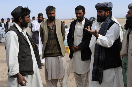Village elders discuss options for disseminating humanitarian aid