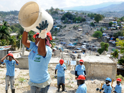 Locals work to remove rubble from a neighborhood in Port-au-Prince