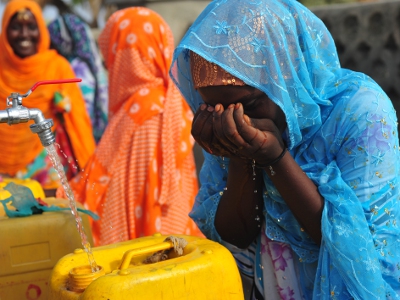 A woman drinks from a public fountain at a village in Assab Eritrea