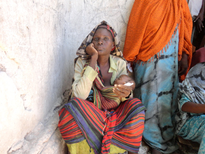 A Somalian woman carrying a child A Somalian woman carrying a child