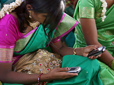 A young woman in Aurangabad, India using two mobile phones A young woman in Aurangabad, India using two mobile phones