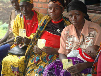 Women hold their health insurance cards in Rwanda