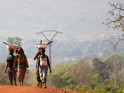 Women walk along the road in Benin